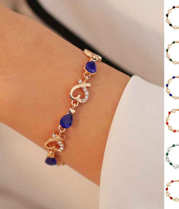 Rhinestone heart charm bracelet with blue teardrop stones and heart charms (on wrist)