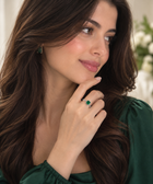 Adjustable micro-paved diamond ring with green square gemstone on woman's finger