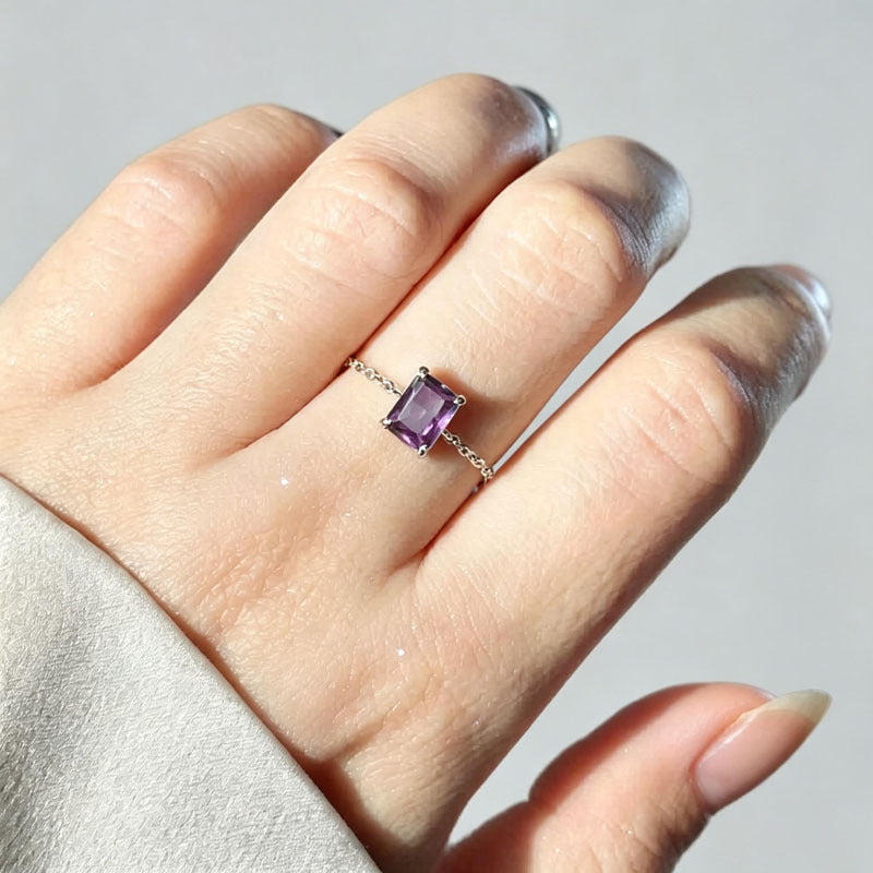 Adjustable micro-paved diamond ring with purple square gemstone worn on finger