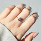 Adjustable micro-paved diamond ring with purple square gemstone worn on finger